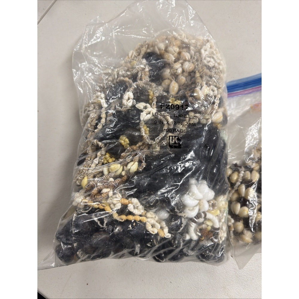 two plastic bags filled w/ bulk collection of VTG Hawaiian shell necklaces 6lbs